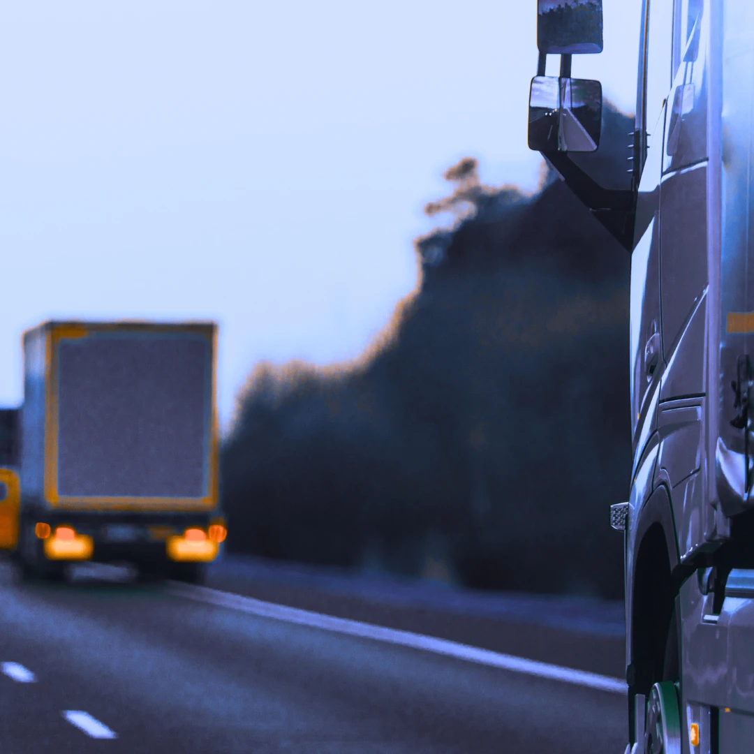 Close-up of a heavy goods vehicle driving on a motorway with another lorry ahead