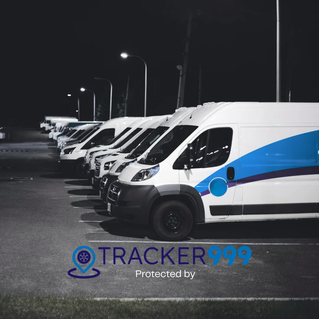 Fleet of white vans parked in a secure depot protected by Wholesale Telematics fleet tracking