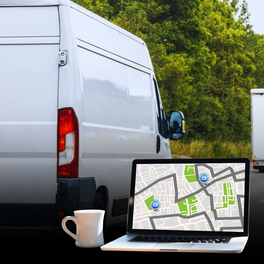Rear view of a white van with a laptop showing live vehicle tracking on a map