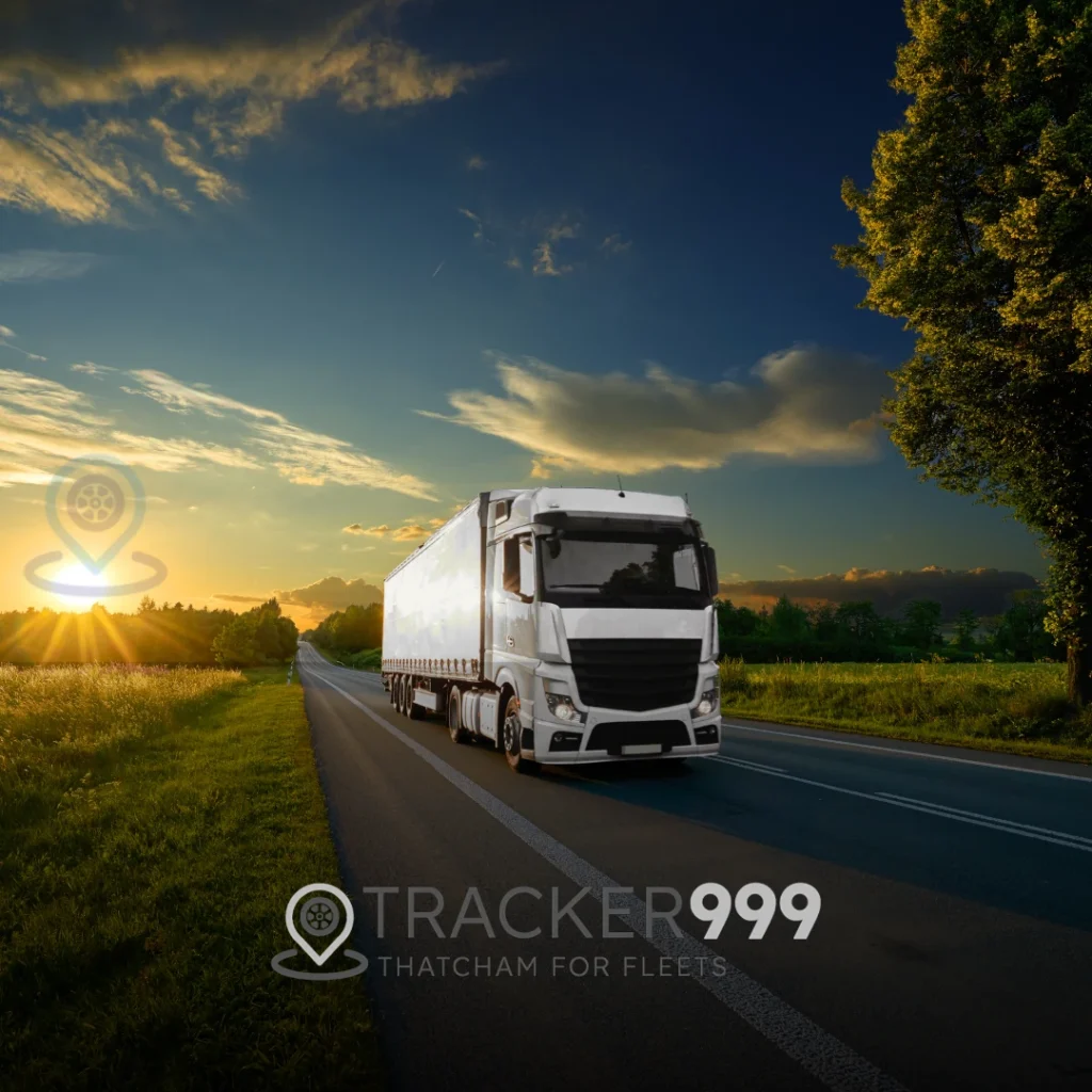 White articulated lorry on countryside road with fleet tracking logo and Wholesale Telematics branding
